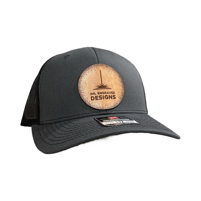 A black cap that features a comopany logo on a circular patch