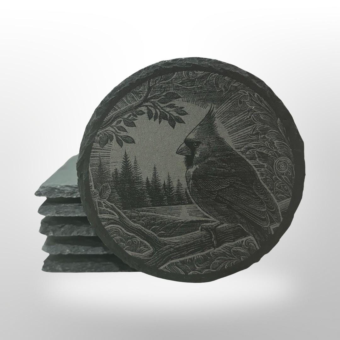 slate coaster with a cardinal engraved onto it